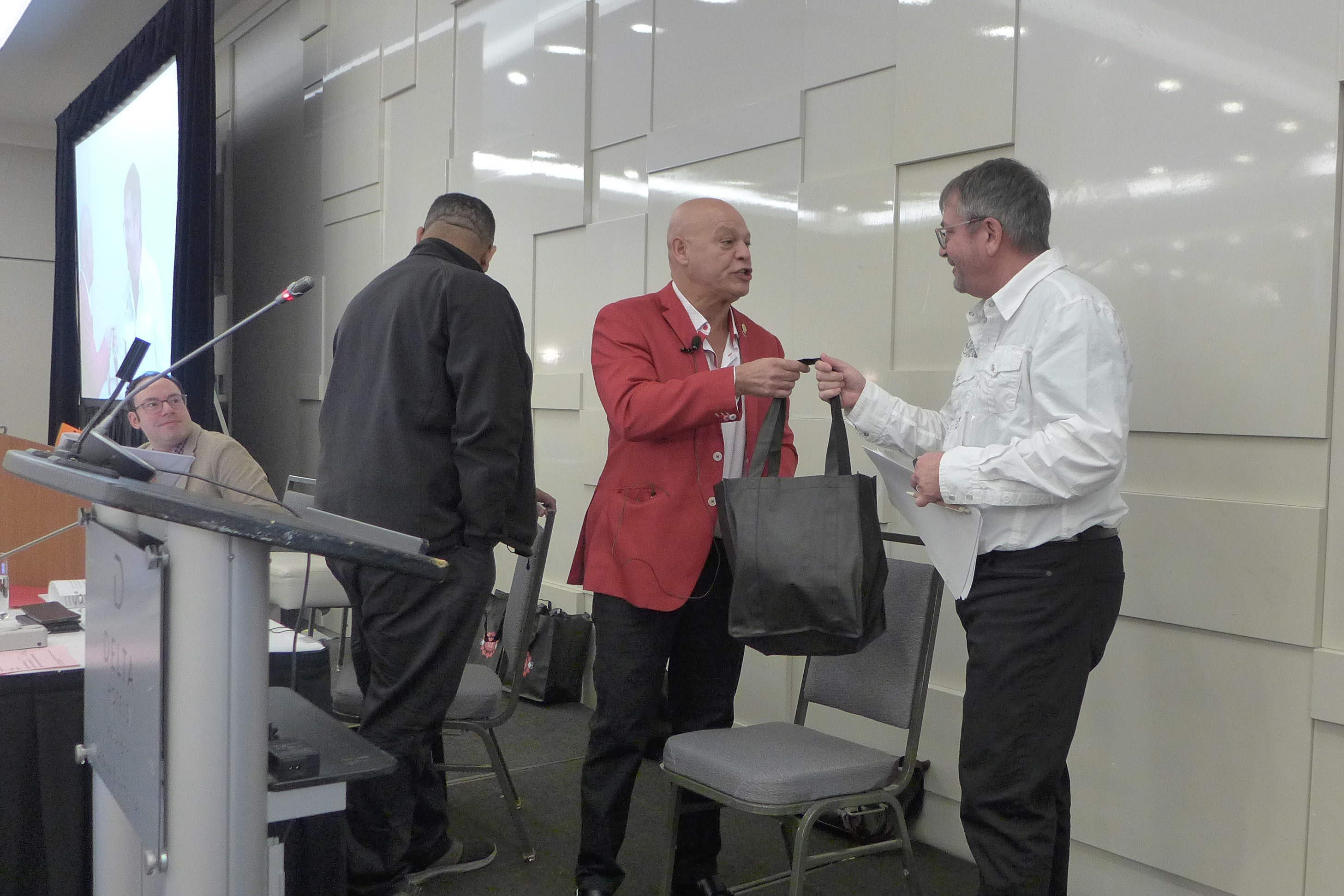 Denis St-Jean receiving a thank-you gift from Doug Gaetz