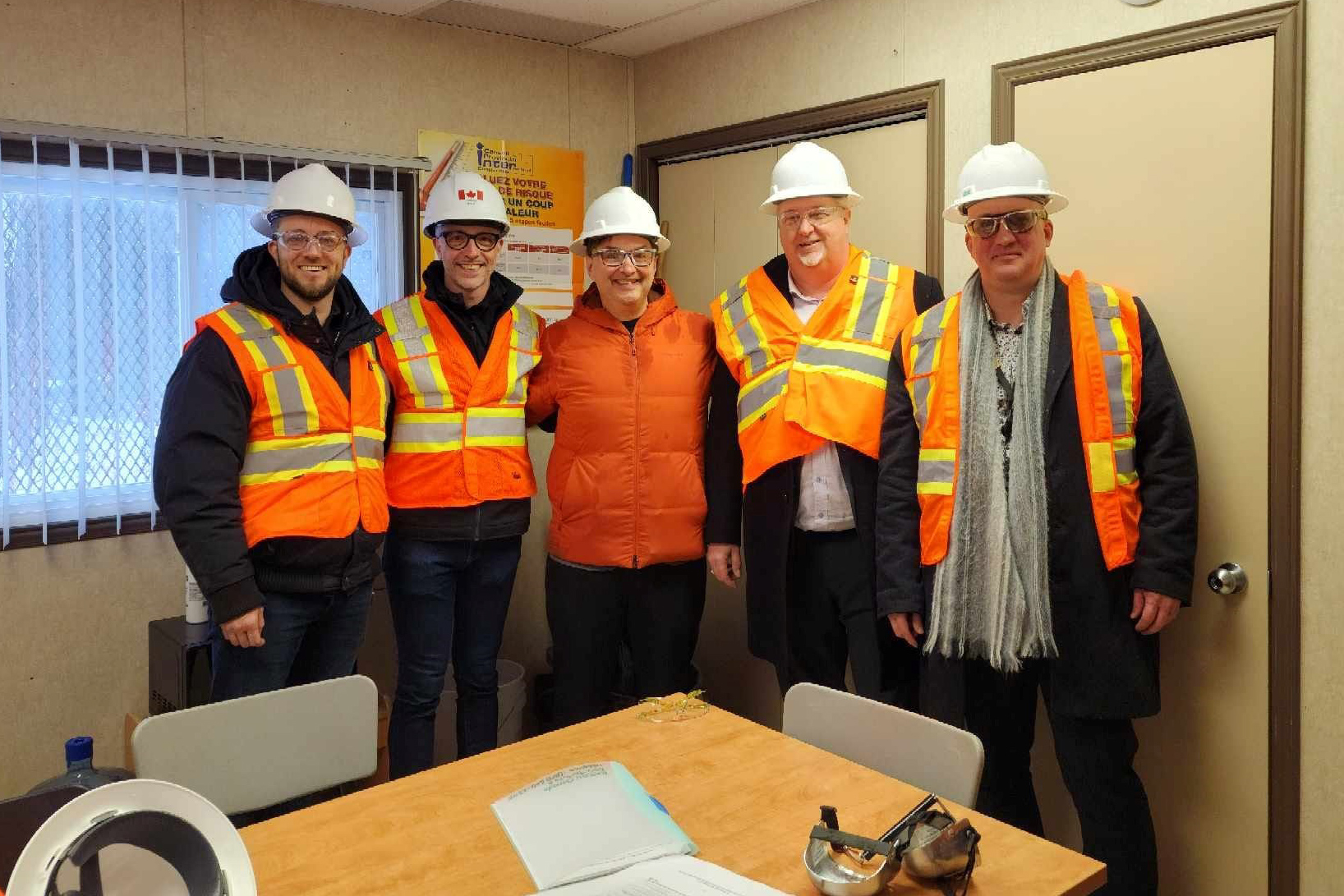 site visit photo with reflective vests and hard hats