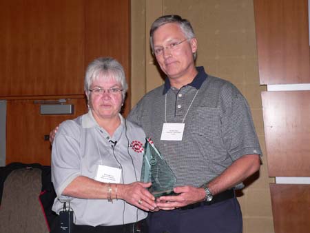 Betty Bannon presents Bill McCallum with the Humanitarian Award