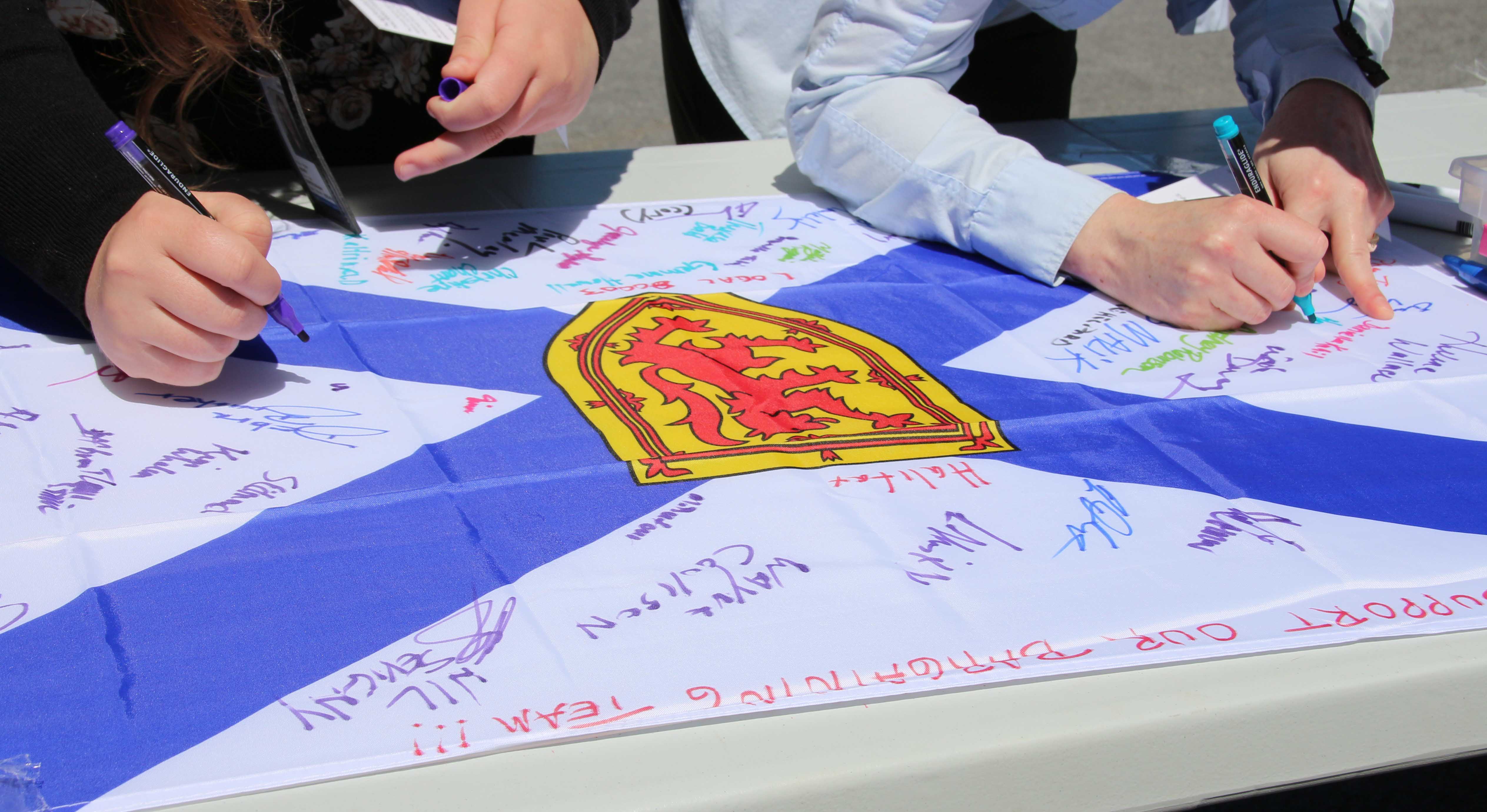 close up of members signing flag