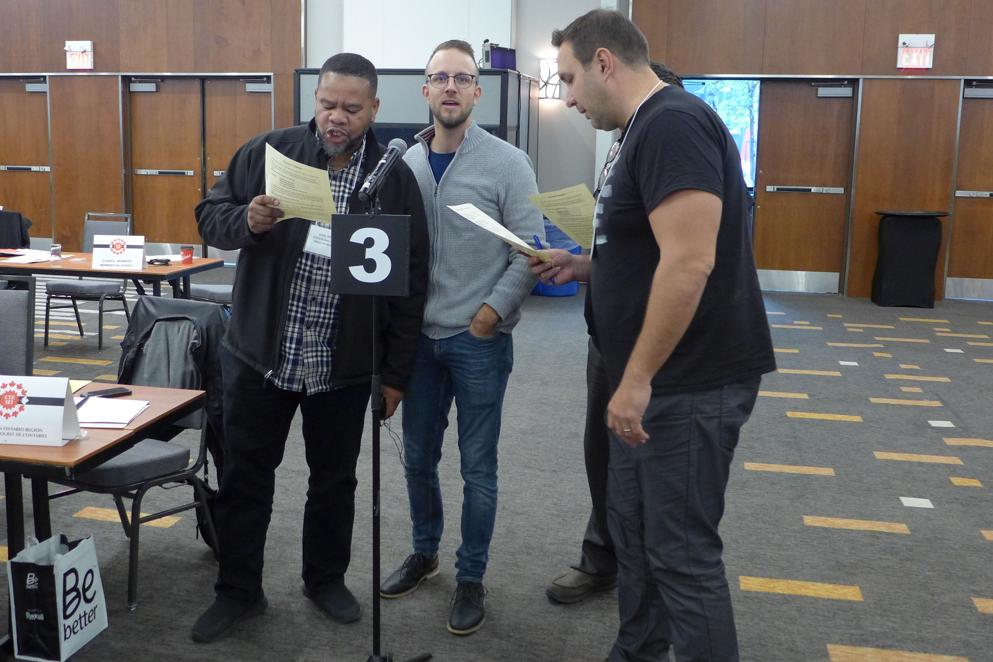 Eddy Aristil, Jérôme Martel and Justin Leinhos singing Solidarity Forever