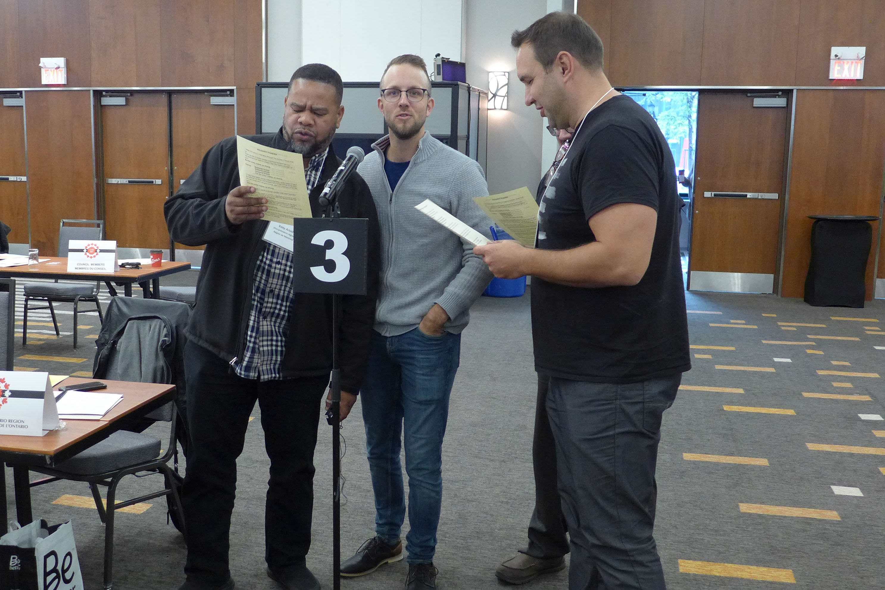 Eddy Aristil, Jérôme Martel and Justin Leinhos singing Solidarity Forever