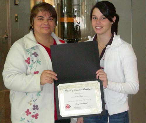 Stephanie Orsini, Treasurer, presents Tanis Martin with the scholarship 