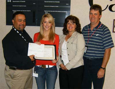 Brittany MacLean and her parents with Joe Parris.