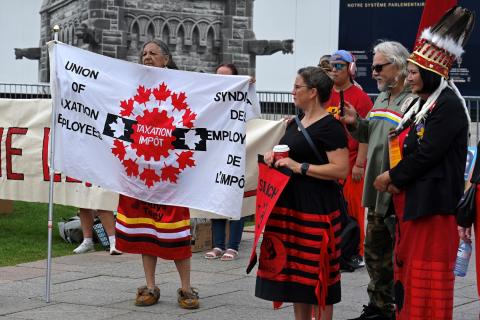 Indigenous woman holding a UTE Flag