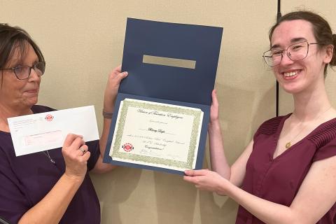 Sharon Clark presenting the award to Briony Doyle